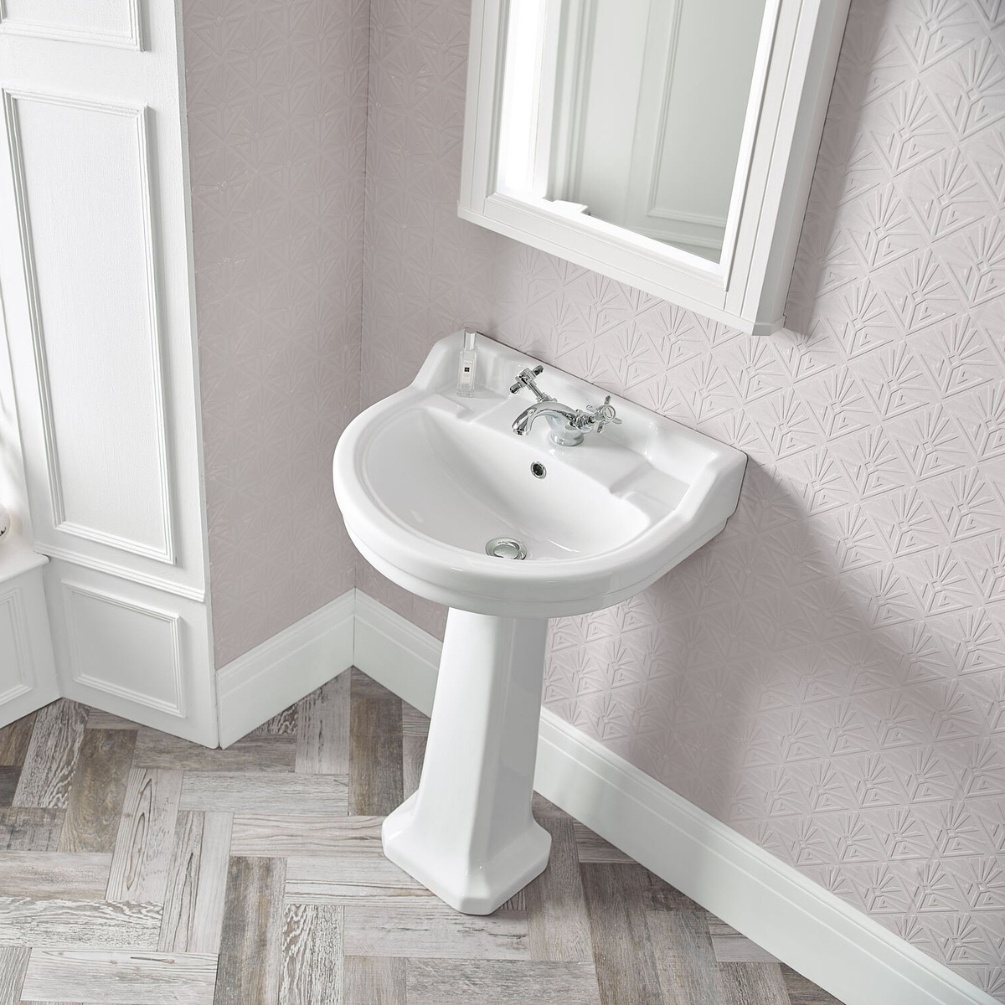 Lifestyle image of the Tavistock Vitoria 550mm 2 Tap Hole Round Basin & Pedestal installed in lightly coloured bathroom, below a mirror